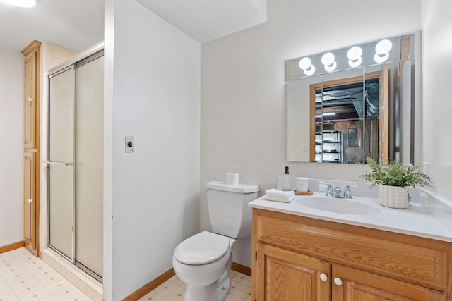27151 Aberdeen Ave, New Prague, MN 56071 - full bathroom with vanity, a stall shower, toilet, tile patterned floors, and baseboards