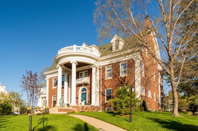 2525 2nd St, Duluth, MN 55812 - neoclassical / greek revival house featuring a balcony, a front yard, and brick siding