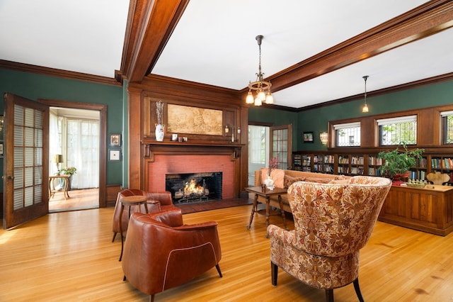 2525 2nd St, Duluth, MN 55812 - living room featuring light wood-style floors, a brick fireplace, beamed ceiling, healthy amount of natural light, and ornamental molding