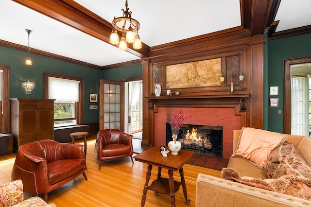 2525 2nd St, Duluth, MN 55812 - living area featuring light wood-type flooring, ornamental molding, a fireplace, plenty of natural light, and radiator