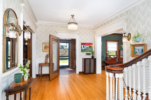 2525 2nd St, Duluth, MN 55812 - entryway with wallpapered walls, light wood finished floors, and ornamental molding