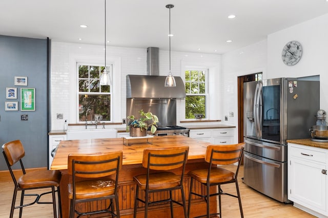 2525 2nd St, Duluth, MN 55812 - kitchen featuring a sink, wood counters, stainless steel refrigerator with ice dispenser, light wood-style floors, and recessed lighting
