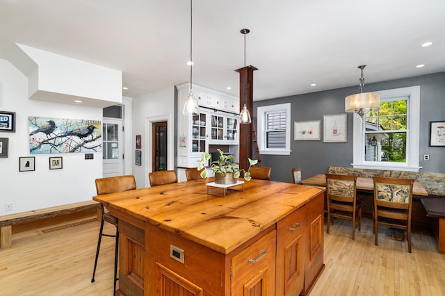 2525 2nd St, Duluth, MN 55812 - kitchen with light wood-style flooring, wood counters, recessed lighting, decorative light fixtures, and a breakfast bar