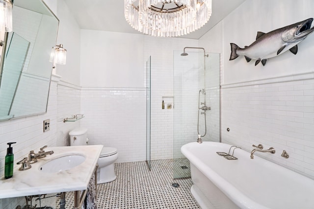2525 2nd St, Duluth, MN 55812 - full bathroom with tile walls, a freestanding bath, tiled shower, toilet, and a chandelier