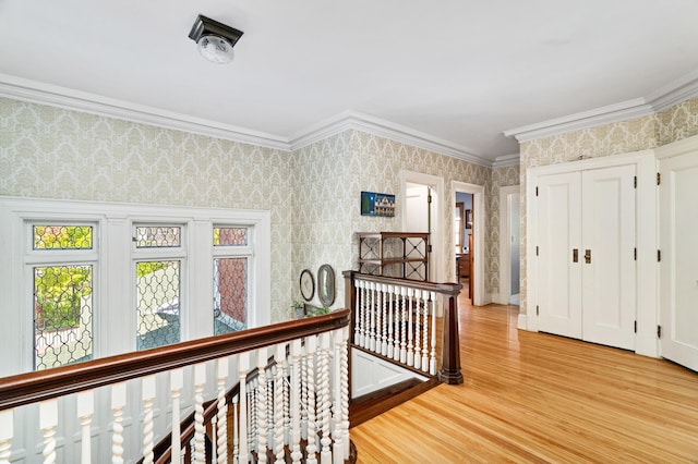 2525 2nd St, Duluth, MN 55812 - hallway with an upstairs landing, light wood finished floors, ornamental molding, and wallpapered walls