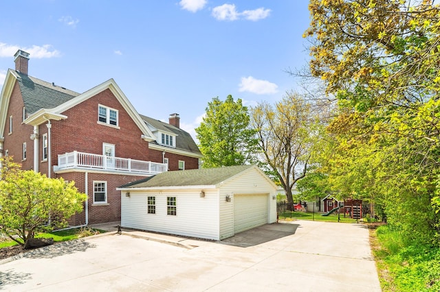 2525 2nd St, Duluth, MN 55812 - back of house featuring a chimney, an outbuilding, a detached garage, a playground, and brick siding