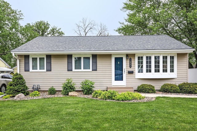 1821 4th Ave NE, Austin, MN 55912 - single story home featuring a front lawn and roof with shingles
