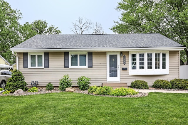 1821 4th Ave NE, Austin, MN 55912 - single story home with a front lawn and a shingled roof