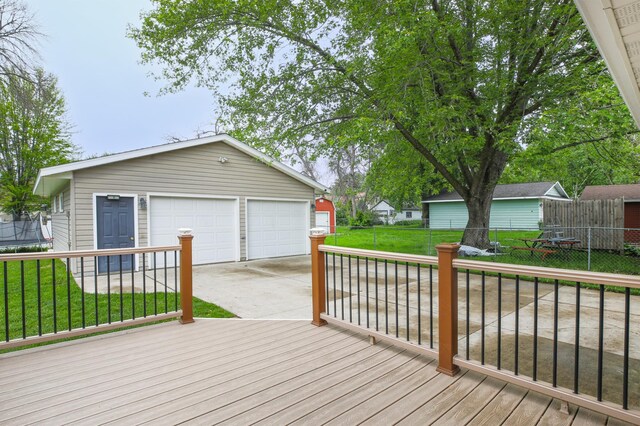 1821 4th Ave NE, Austin, MN 55912 - wooden terrace featuring an outdoor structure, a garage, and driveway
