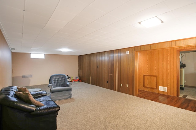 1821 4th Ave NE, Austin, MN 55912 - sitting room with carpet flooring, wooden walls, and water heater