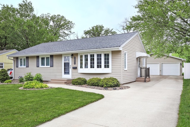 1821 4th Ave NE, Austin, MN 55912 - ranch-style house with an outdoor structure, a garage, a front yard, and roof with shingles