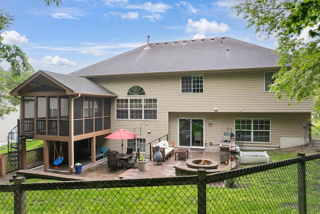 14925 Hillside Trl, Savage, MN 55378 - back of property featuring a patio area, a sunroom, an outdoor fire pit, and a shingled roof