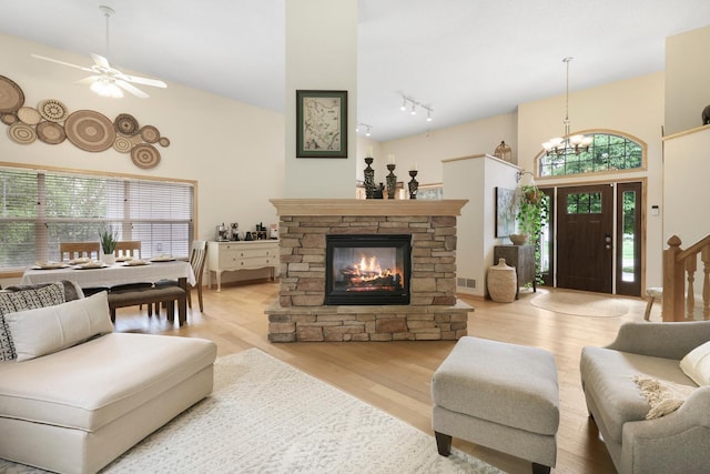 14925 Hillside Trl, Savage, MN 55378 - living room with a high ceiling, a ceiling fan, wood finished floors, track lighting, and a chandelier