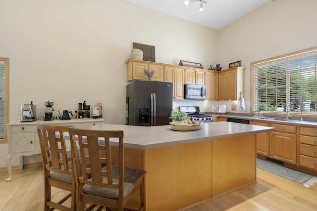 14925 Hillside Trl, Savage, MN 55378 - kitchen featuring fridge with ice dispenser, stainless steel microwave, range, a sink, and light wood-style floors