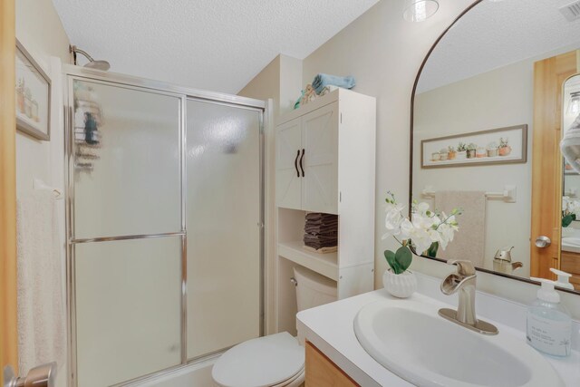 14925 Hillside Trl, Savage, MN 55378 - full bath featuring vanity, an enclosed shower, a textured ceiling, and toilet