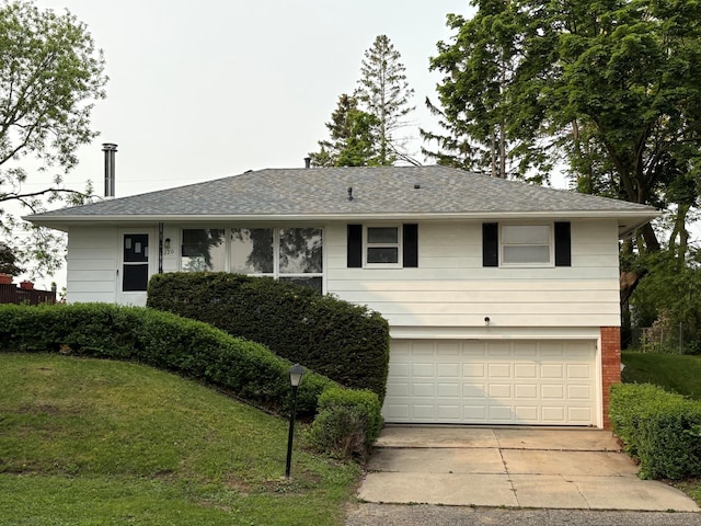 2220 23rd St NW, Rochester, MN 55901 - view of front of property with an attached garage, concrete driveway, a front yard, and a shingled roof