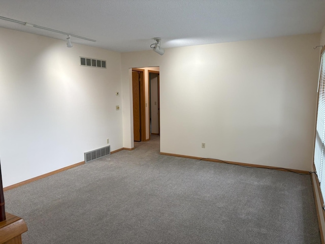 2220 23rd St NW, Rochester, MN 55901 - carpeted empty room with track lighting and baseboards