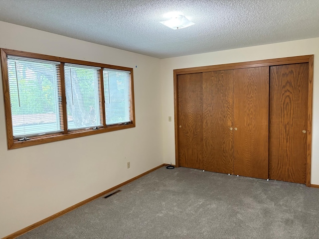 2220 23rd St NW, Rochester, MN 55901 - unfurnished bedroom with carpet flooring, a closet, a textured ceiling, and baseboards