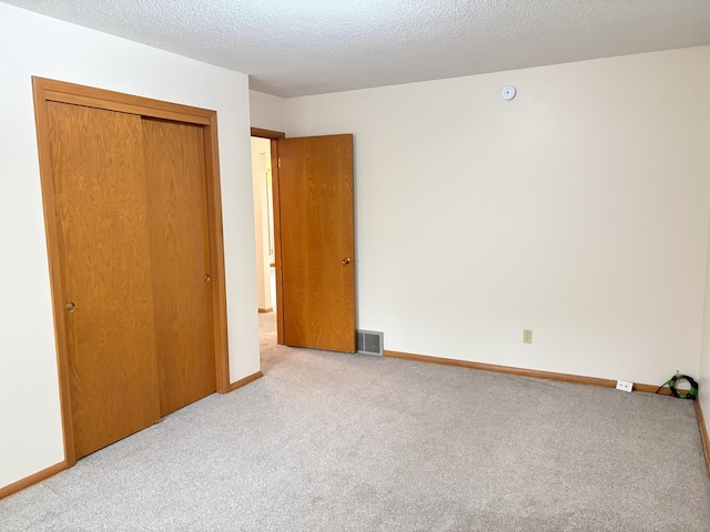 2220 23rd St NW, Rochester, MN 55901 - unfurnished bedroom with carpet, a closet, baseboards, and a textured ceiling