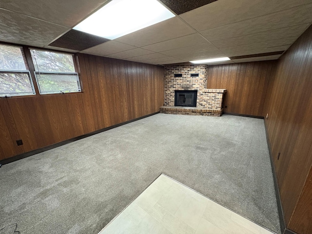 2220 23rd St NW, Rochester, MN 55901 - basement featuring a fireplace, wood walls, a paneled ceiling, and light carpet