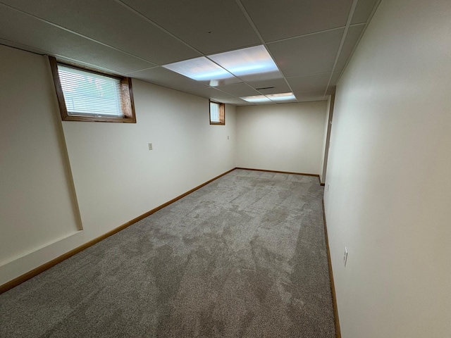 2220 23rd St NW, Rochester, MN 55901 - below grade area featuring carpet flooring, a drop ceiling, and baseboards