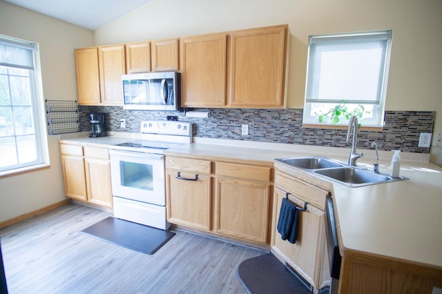 450 Meadow Ln, Somerset, WI 54025 - kitchen featuring stainless steel microwave, white range with electric stovetop, light brown cabinets, a sink, and light wood-type flooring