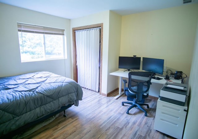450 Meadow Ln, Somerset, WI 54025 - bedroom featuring wood finished floors, an office area, baseboards, and a closet