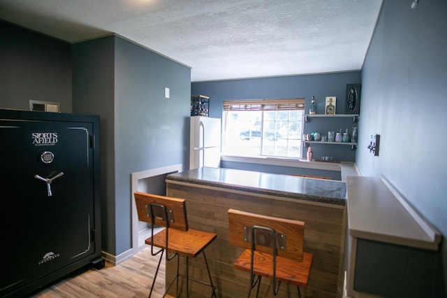 450 Meadow Ln, Somerset, WI 54025 - bar with freestanding refrigerator, wood finished floors, and a textured ceiling