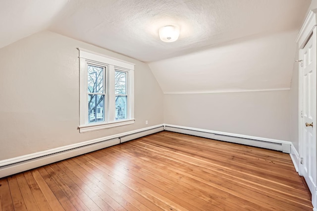 1156 Marion St, Saint Paul, MN 55117 - bonus room with lofted ceiling, hardwood / wood-style floors, baseboards, a textured ceiling, and baseboard heating