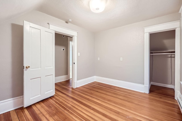 1156 Marion St, Saint Paul, MN 55117 - unfurnished bedroom featuring light wood finished floors, a closet, baseboards, and a textured ceiling