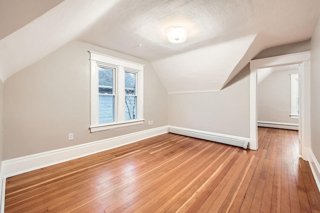 1156 Marion St, Saint Paul, MN 55117 - bonus room with baseboard heating, hardwood / wood-style flooring, a baseboard heating unit, lofted ceiling, and baseboards