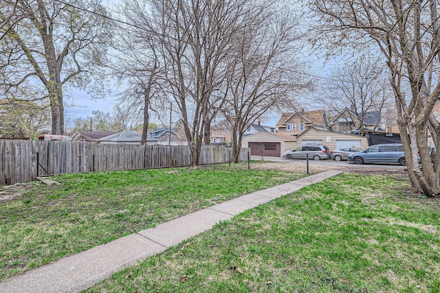 1156 Marion St, Saint Paul, MN 55117 - view of yard featuring a detached garage, a residential view, and driveway