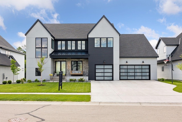 6297 Yuma Ln N, Maple Grove, MN 55311 - view of front of house with concrete driveway, stucco siding, a front lawn, stone siding, and a garage