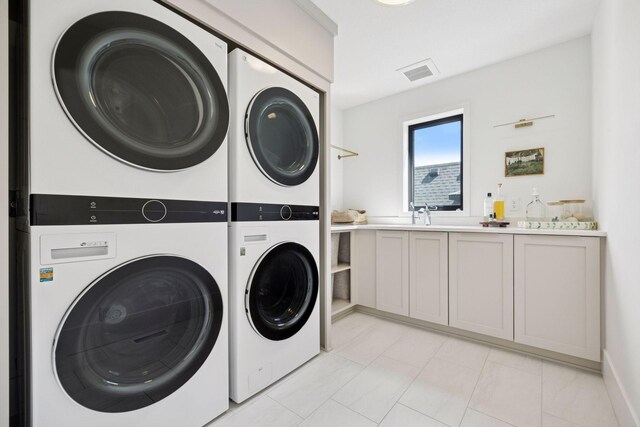 6297 Yuma Ln N, Maple Grove, MN 55311 - laundry room with stacked washer / drying machine, washing machine and dryer, and cabinet space