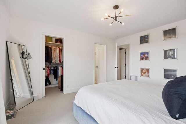 6297 Yuma Ln N, Maple Grove, MN 55311 - bedroom with a chandelier, light carpet, a walk in closet, a closet, and baseboards