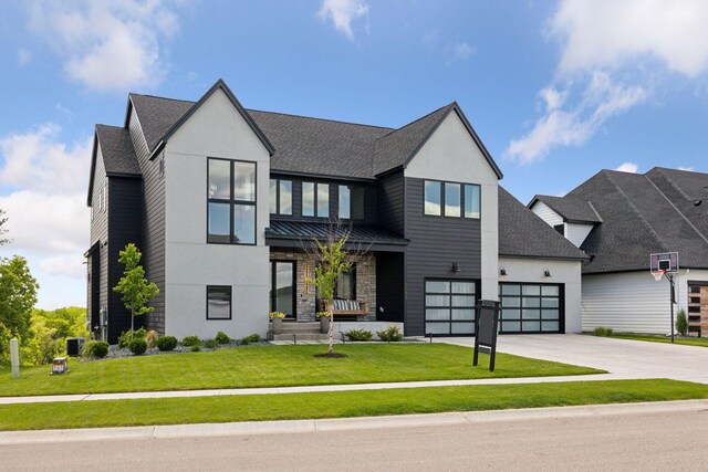6297 Yuma Ln N, Maple Grove, MN 55311 - contemporary home with concrete driveway, a front lawn, a shingled roof, and stucco siding