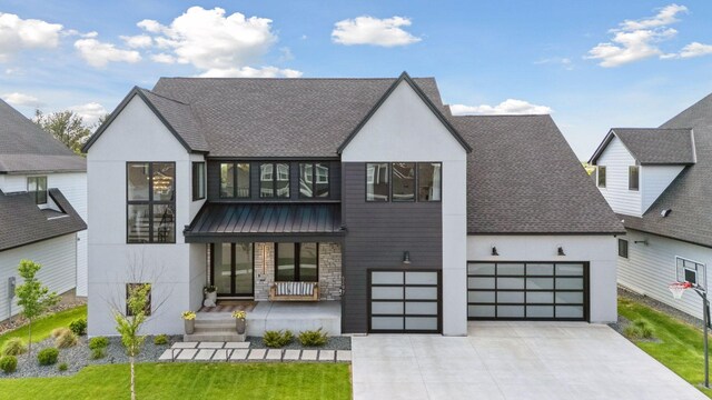 6297 Yuma Ln N, Maple Grove, MN 55311 - contemporary house with covered porch, stucco siding, driveway, roof with shingles, and stone siding