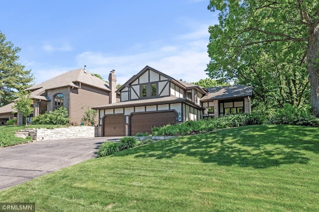 12143 Gantry Ln, Apple Valley, MN 55124 - tudor home featuring driveway, a front lawn, and a chimney