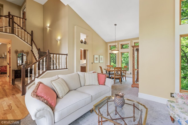 12143 Gantry Ln, Apple Valley, MN 55124 - living area featuring high vaulted ceiling, stairs, and baseboards
