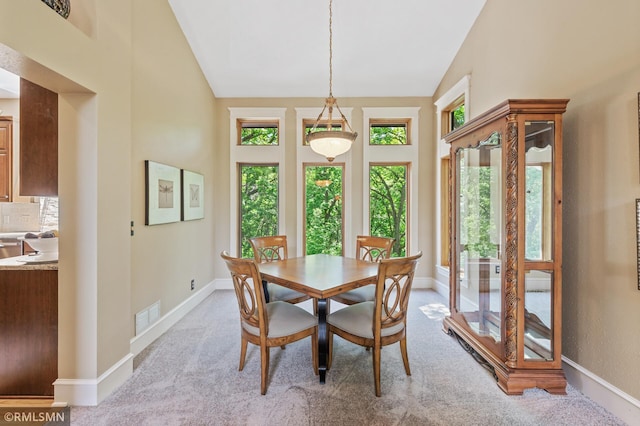 12143 Gantry Ln, Apple Valley, MN 55124 - dining area featuring vaulted ceiling, light carpet, and baseboards