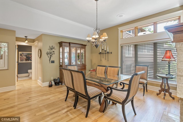 12143 Gantry Ln, Apple Valley, MN 55124 - dining room with light wood finished floors, baseboards, and a chandelier