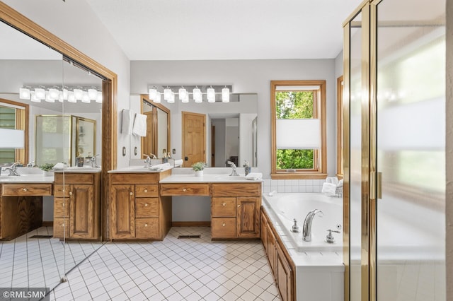 12143 Gantry Ln, Apple Valley, MN 55124 - bathroom featuring two vanities, a stall shower, a bath, and tile patterned flooring