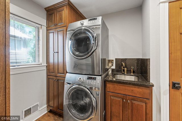 12143 Gantry Ln, Apple Valley, MN 55124 - washroom with stacked washer / drying machine, cabinet space, plenty of natural light, and bar with sink