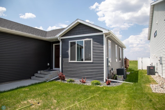 2700 14th St W, West Fargo, ND 58078 - back of house featuring a yard and central AC unit
