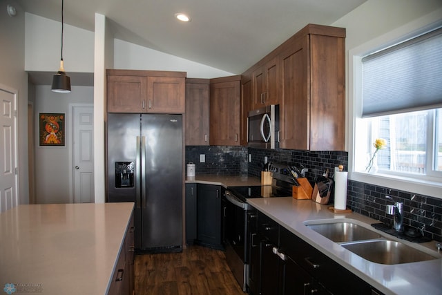 2700 14th St W, West Fargo, ND 58078 - kitchen with appliances with stainless steel finishes, tasteful backsplash, dark wood-style floors, lofted ceiling, and light countertops