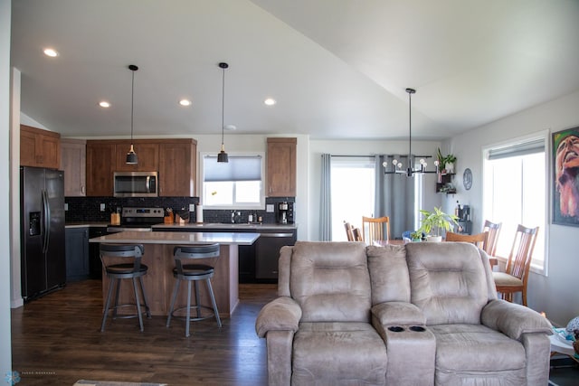2700 14th St W, West Fargo, ND 58078 - kitchen with appliances with stainless steel finishes, lofted ceiling, open floor plan, healthy amount of natural light, and a chandelier