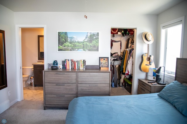 2700 14th St W, West Fargo, ND 58078 - bedroom with carpet, a closet, a spacious closet, ensuite bathroom, and baseboards