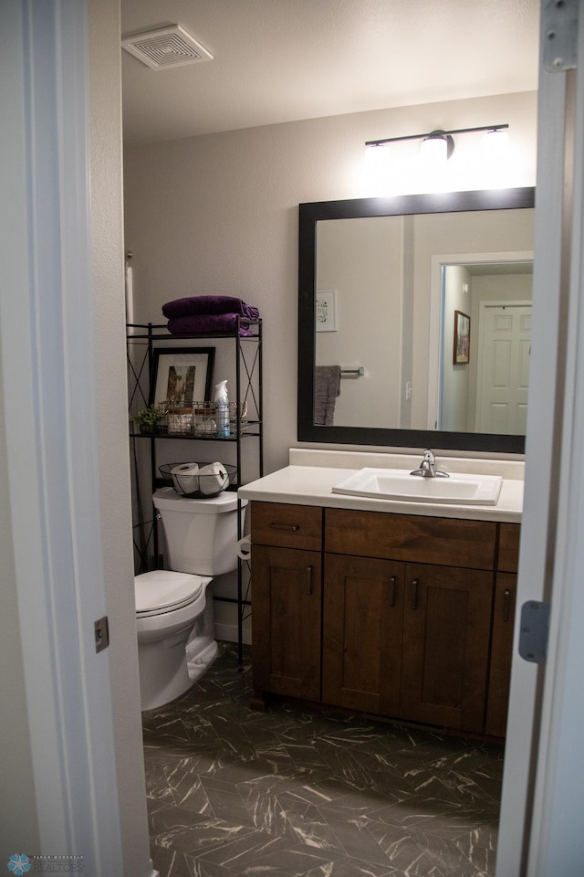 2700 14th St W, West Fargo, ND 58078 - bathroom featuring marble look tiles, vanity, and toilet