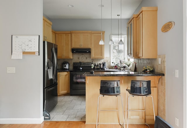 1712 Levee Ave, Anoka, MN 55303 - kitchen with black electric range, fridge with ice dispenser, a peninsula, dark countertops, and under cabinet range hood