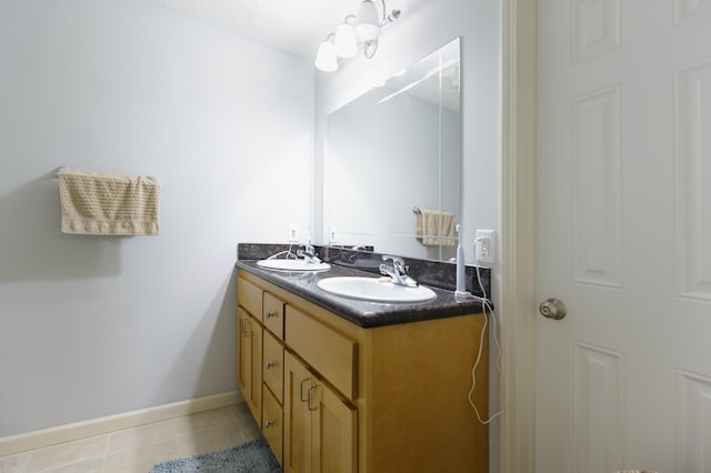 1712 Levee Ave, Anoka, MN 55303 - bathroom with double vanity, tile patterned floors, and baseboards